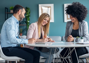 Happy young couple signing bank loan agreement with real-estate Enhancing corporate credit